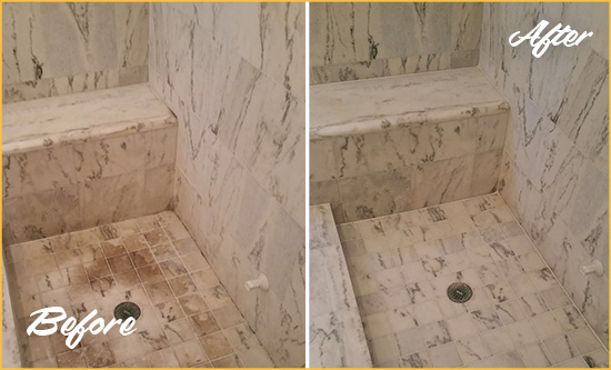 Before and After Picture of a Dirty Ball Ground Marble Shower Cleaned to Eliminate Dark Stains